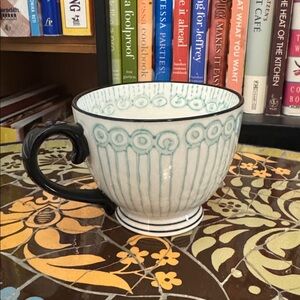 Elegant Black and White Teacup with Blue Accents